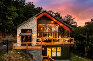 a house with a wrap around porch with a wrap around deck at Midnight Mountain in Sevierville