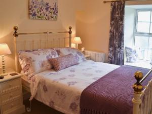 a bedroom with a bed and a window at Sunloch Cottage in St Just +7 photos