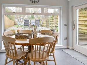 a dining room with a wooden table and chairs at Buckle House in Gatehouse of Fleet