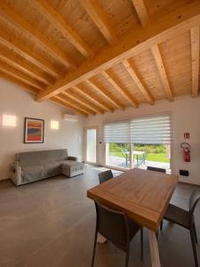 a large living room with a wooden table and a bed at Chalet Marghe 2 in Rovetta +7 photos