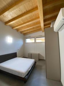 a bedroom with a bed and a wooden ceiling at Chalet Marghe 2 in Rovetta