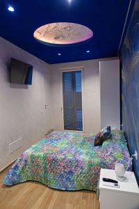 a bedroom with a large bed with a large comforter at Starry Sky House in Mola di Bari