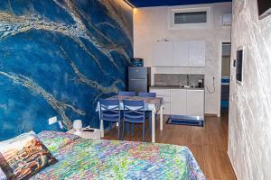 a bedroom with a painting of a wave on the wall at Starry Sky House in Mola di Bari