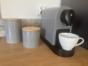 a coffee maker and a cup on a table at Tiny House at Deer Trail Tatranska Lomnica in Tatranská Lomnica +16 photos