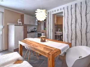 a kitchen with a table and a dining room at Forest-Fringed Comfort in Friedrichshöhe