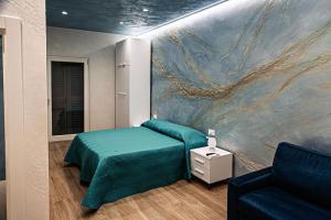 a bedroom with a bed and a painting on the wall at Starry Sky House in Mola di Bari