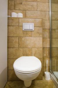 a bathroom with a toilet and a wall with towels at B&B Tonivale in Skrbčići