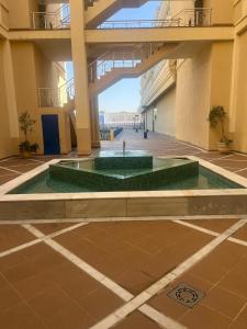 a large building with a fountain in the middle at Apartamento lux capilla in Seville +25 photos