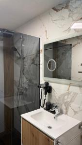 a bathroom with a sink and a shower at La Brazi by BMD in Vulcan