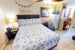 a bedroom with a bed and a refrigerator at Ocean Jewel Condo Unit 303 in Daytona Beach