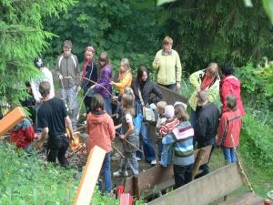a group of people standing around a fire at Holiday Home with Garden in Altenfeld
