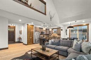 a living room with a couch and a table at Prospector Pines Treetop Escape in Suncadia- Fairway View, BBQ, Outdoor Fireplace, Smart TVs, Hi-speed Wi-Fi in Cle Elum +36 photos