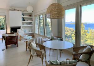 a living room with a table and chairs at Ktima Bird Paradise in Yénion