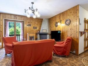 a living room with wooden walls and a table and chairs at Apartment Leonardi Terrace by Interhome in Campodolcino