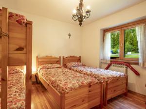 a bedroom with two twin beds and a window at Apartment Leonardi Terrace by Interhome in Campodolcino