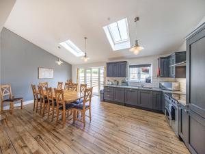 a kitchen and dining room with a table and chairs at Cor Tarw - Uk12743 in Acrefair