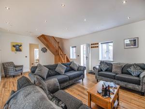 a living room with two couches and a table at Cor Tarw - Uk12743 in Acrefair