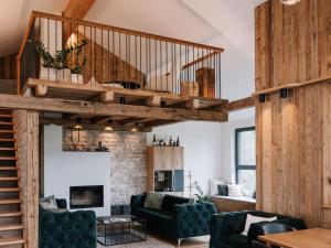 a living room with a loft with a staircase at Holiday Home Haus am Kogl by Interhome in Wies +57 photos