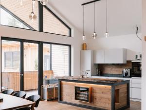 a kitchen with a fireplace in the middle of a room at Holiday Home Haus am Kogl by Interhome in Wies