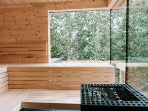 a sauna with a bench and a window at Holiday Home Haus am Kogl by Interhome in Wies