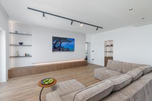 a living room with a couch and a table at Penthouse Andro, Omis in Omiš