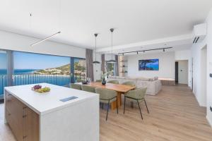 a kitchen and dining room with a view of the ocean at Penthouse Andro, Omis in Omiš