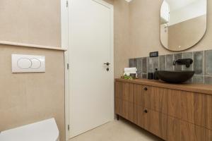 a bathroom with a sink and a mirror at Penthouse Andro, Omis in Omiš +47 photos