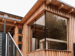 a wooden house with a large glass window at Holiday Home Haus am Kogl by Interhome in Wies