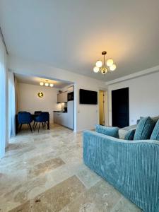 a living room with a blue couch and a table at Billy&Ane Apartments,Rooms in Sinaia