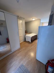 a room with a bed and a white refrigerator at Midt i byen in Trondheim +9 photos