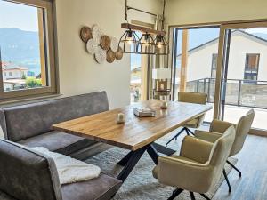 a dining room with a wooden table and chairs at Chalet Ossiacher See Chalet 2 by Interhome in Bodensdorf