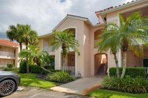 a house with palm trees in front of it at Sunny Port St Lucie Condo Golf, Swim and Unwind! in Carlton