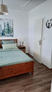a bedroom with a bed with a wooden bed frame at Ferienwohnung Pusterhofer in Rettenegg