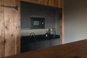 a kitchen with a sink and a microwave at 'SLOE at Daniels in Gloucestershire