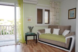 a living room with a couch and a balcony at Apartment Splitska in Splitska