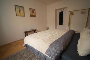 a bedroom with a bed with a blanket on it at Apartmán u Leny in Muglinov
