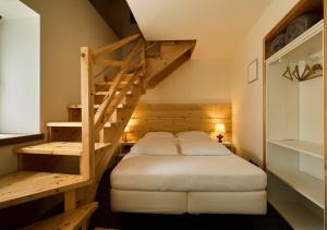 a bedroom with a bunk bed and a staircase at BeB CasaCuore Presolana in Castione della Presolana