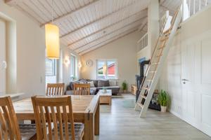a living room with a wooden table and a ladder at Marie in Dagebüll +13 photos