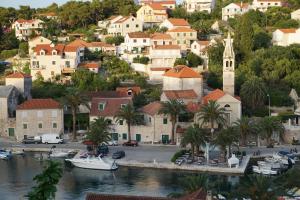 a town on a hill with boats in a harbor at Apartment Splitska in Splitska