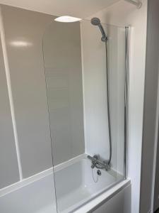 a shower in a bathroom with a glass door at Victoria House in Littleport +11 photos