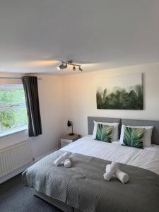 a bedroom with a bed with two stuffed animals on it at Victoria House in Littleport