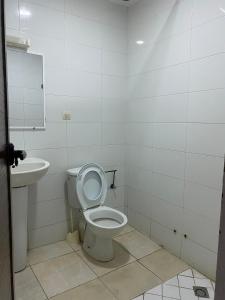 a bathroom with a toilet and a sink at Hotel Soukina in Dakhla +8 photos