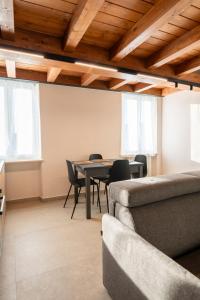 a living room with a dining room table and chairs at Dimora del Mincio in Monzambano +31 photos