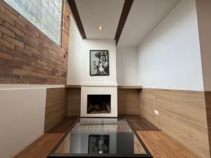 a living room with a fireplace and a brick wall at Apartaestudios La Candelaria in Bogotá