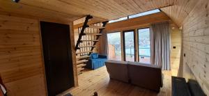 a room with a staircase in a wooden house at Belas guesthouse in Kazbegi