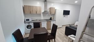 a kitchen and living room with a table and a dining room at El Rincón de Perez A in Ajo