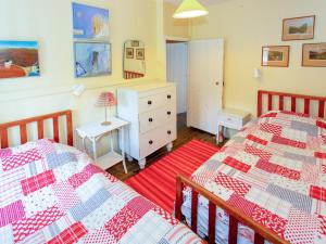 a bedroom with two beds and a dresser at Red - Uk43121 in Trefor