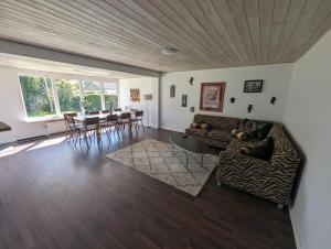 a living room with a couch and a table at Suburban house in Rødbyhavn in Rødby