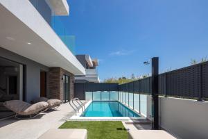 a swimming pool in the backyard of a house at VillaSaints I Private Pool Villas, Walk to Beach, BBQ in Chania Town