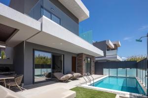 an image of a house with a swimming pool at VillaSaints I Private Pool Villas, Walk to Beach, BBQ in Chania Town